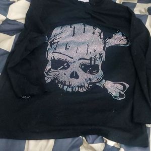 A large black, rinstone. Is a long sleeve and very comfortable.